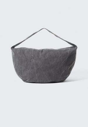 Gray fabric bag with a distinctive textured surface, curved shape, and a soft, wide shoulder strap for easy carrying.