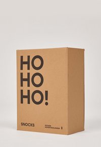 Scatola in kraft marrone con testo nero che recita "HO HO HO!" e "SNOCKS SOCKEN ADVENTSKALENDER." Forma quadrata, design minimalista.
