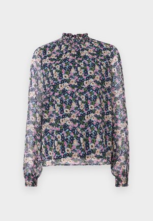 Blusa floral con cuello alto, mangas largas y puños elásticos. La tela transparente presenta un fondo azul marino y coloridos patrones de flores.