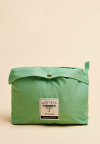 Zaļš iepakojams soma, kas izgatavota no gludas, ūdensizturīgas auduma. Iespējas iekļauj salocamu klp, snap slēgšanu un etiķeti ar lietus un lietussarga logotipu.