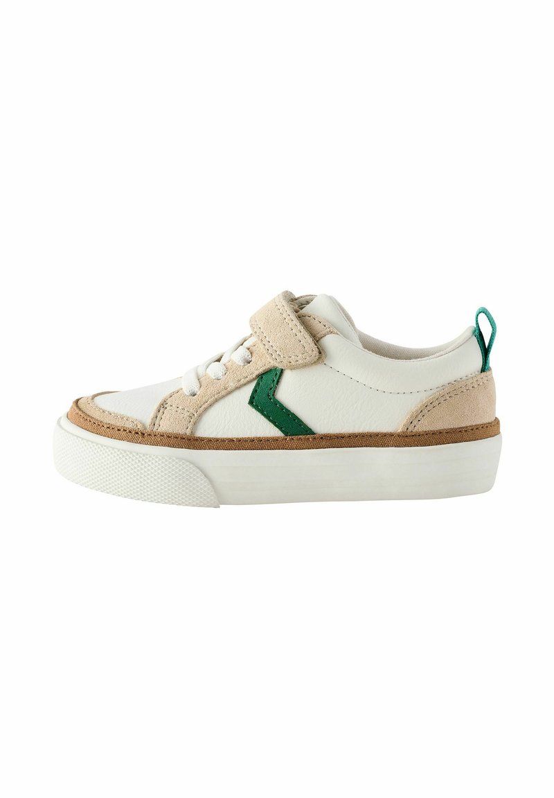 White and beige sneaker with a textured finish, green accents, and a Velcro strap. Features a thick white rubber sole.