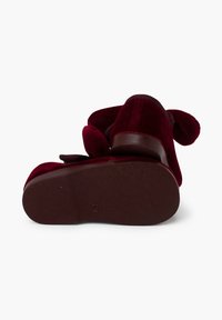 Bordeaux fluwelen schoenen met een gladde ronde neus, elastische band en een gestructureerde bruine rubberen zool. Strikaccent op de bovenkant.