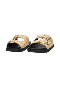 Beige woven slide sandals with two metallic buckle accents, black sole, open toe design, and textured upper.