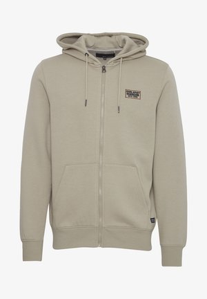 Beige zip-up hoodie gemaakt van een zachte katoenmix, met een voorste kangoeroezak, een capuchon met trekkoorden en een klein logo-merkje op de borst.