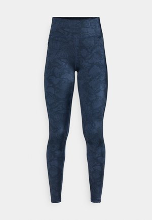 Leggings mit Marine-Muster, ausgestattet mit einem hohen Bund, aus elastischem Material gefertigt, mit einer subtilen Textur, die an Schlangenleder erinnert.