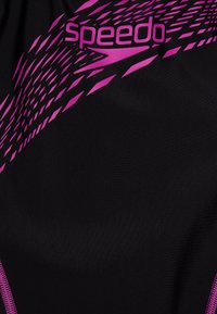 Speedo swimsuit featuring a black material with a pink geometric pattern and logo, smooth texture, and a snug fit design.