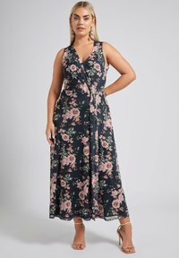 Yömpäri mekko tummansinisellä pohjalla, jossa on vaaleanpunaisia ja vihreitä kukkakuosia. Ominaisuuksina hihaton malli, V-pääntie ja solmittava vyötärö. Kevyt ja ilmava kangas.