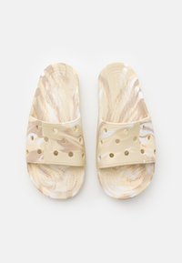 Pantofole scivolose marmorizzate in beige chiaro e crema, realizzate in morbido gomma, con perforazioni sulla cintura per ventilazione e comfort.