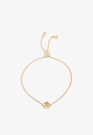 Gold bracelet featuring a chain design with a flower-shaped charm at the center, textured petals, and an adjustable sliding clasp.