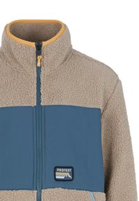 Chaqueta de forro polar con un cuerpo beige y un panel frontal azul oscuro, cuenta con un cuello alto, cremallera completa y acentos cosidos. Logo en el pecho.