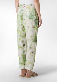 Linnen, lichtgroene en witte bloemenprint broek met een losse pasvorm, elastische tailleband en één achterzak. Opgerolde mouwen als detail.