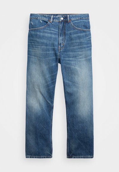 Blue denim jeans with a straight cut, featuring a light wash, slight fading, and subtle distressing near the pockets. Copper rivets visible.