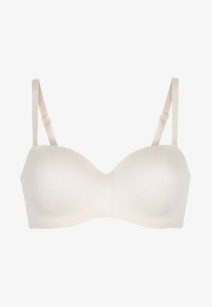 Beige molded bra with smooth cups, adjustable straps, and a seamless design. Features a U-shaped center for enhanced fit and comfort.