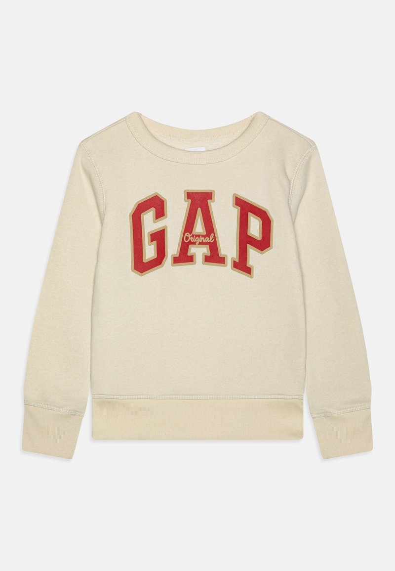 Sweat-shirt à manches longues couleur crème avec poignets et ourlet côtelés, comportant de grandes lettres rouges "GAP" et un petit texte "Original" au centre.