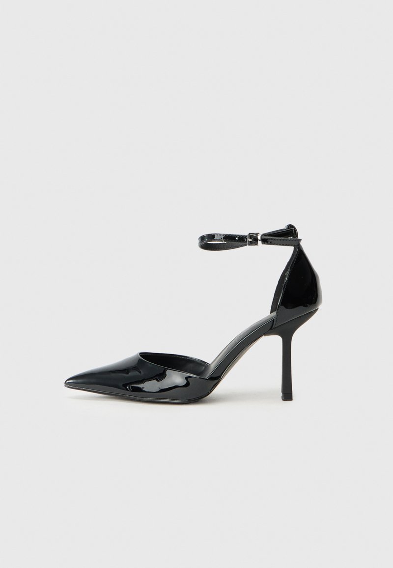 Scarpa nera in pelle verniciata con tacco alto, punta affilata, cinturino alla caviglia e tacco stiletto sottile; texture liscia e lucida e design minimalista.