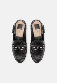 Black leather slip-on shoes with studded accents. Features a rounded toe and textured detail, with a cushioned insole and adjustable strap.