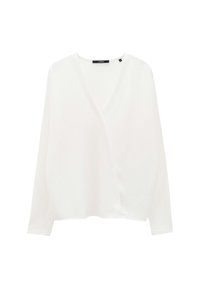Haut blanc à manches longues avec un décolleté en V profond, coupe ample et texture douce. Présente un détail d'étiquette près du col.