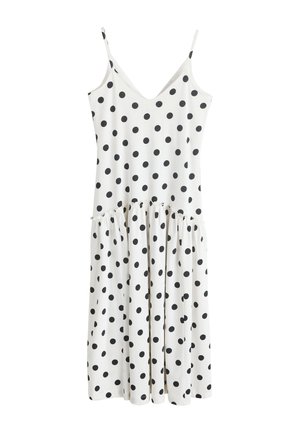 Robe midi blanche sans manches avec fines bretelles et pois noirs, avec une couture froncée à la taille basse.