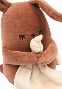 Brown plush rabbit with a textured body and floppy ears, holding a cream-colored blanket in front. Simple facial features and minimal detailing.