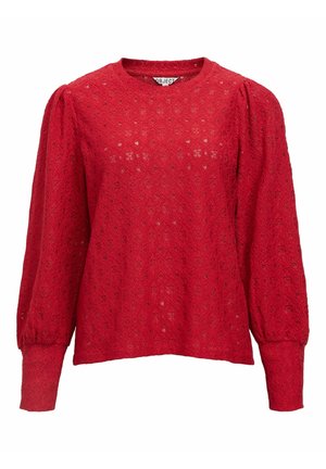 Haut rouge à manches longues en dentelle texturée, avec un col rond, des manches bouffantes et une coupe ample avec un ourlet droit.