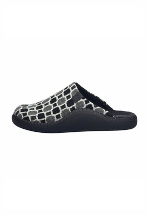 Black and white patterned slip-on shoe with a soft fabric upper, rubber sole, and textured surface. Curved silhouette with a wide opening.