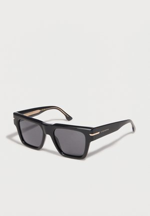 Black rectangular sunglasses with dark lenses featuring gold accents on the temples and Victoria Beckham branding on the side.