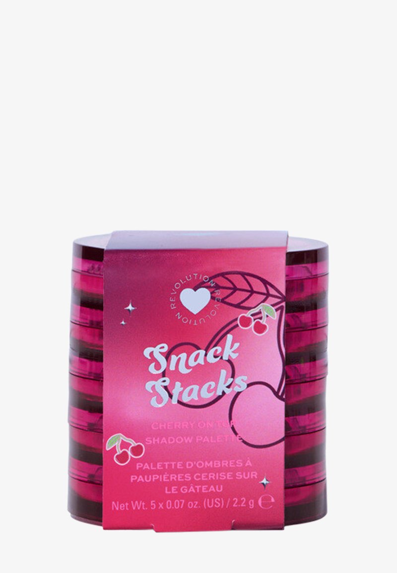 Kirsikka-teemainen luomiväripaletti sylinterimäisessä, kiiltävän vaaleanpunaisessa kotelossa, jossa on mustia raitoja ja tekstiä; sisältää kuusi pientä lokeroa varjostuksia varten.