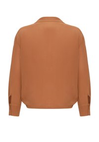 Langsleeve, knoopshirt in verbrande sinaasappel. Gladde stof met een ontspannen pasvorm, met zijsplitten en een klassieke kraag.