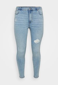 Skinny jeans in light blue denim with a faded finish, featuring a ripped detail on the right knee and traditional five-pocket design.
