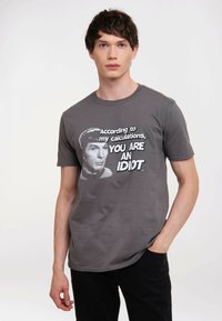 Gray cotton t-shirt featuring a graphic print of a character's face with the text "According to my calculations, YOU ARE AN IDIOT."