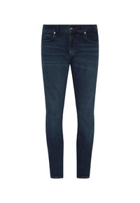 Dünne Jeans aus dunkelblauem Denim. Verfügt über fünf Taschen, einen Knopfverschluss und subtile Nähte entlang der Nähte.