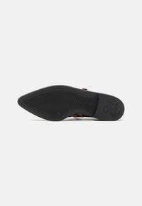 Brown patterned sandal with a textured black rubber sole. Features a sleek design and branded detail on the sole.