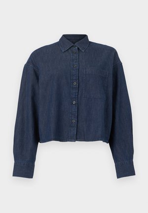 Tumed sinise teksariidest lühendatud särk, millel on pikad varrukad, ees nupud, krae ja üks rinnatasku, valgel taustal.