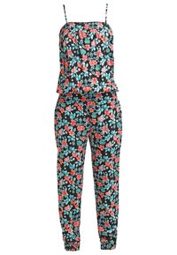 Combinaison sans manches femme avec base noire et motif floral rouge et bleu vif, avec fines bretelles et poignets élastiques aux chevilles.