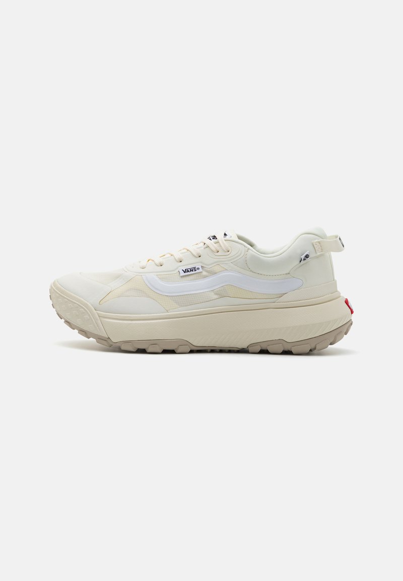White sneakers with a textured cream upper, a chunky sole, and a contrasting red accent on the back. Features a mesh design and logo.