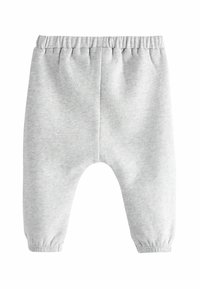 Grijze katoenen joggingbroek met een elastische tailleband, taps toelopende boorden en een losse pasvorm. Zachte textuur met een eenvoudig ontwerp en geen zichtbare patronen.