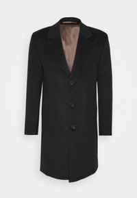 Černý vlněný kabát s hnědou saténovou podšívkou, klopovými límci, pěti knoflíky a bočními kapsami. Přiléhavý střih a strukturovaný silueta.