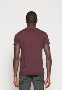 Burgundy short-sleeve T-shirt with a round neckline and a smooth texture, featuring a classic fit, no visible logos or patterns.