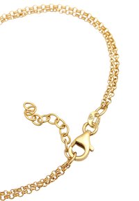 Guldtonad metallkedja med sammanlänkade länkar, med en krabba och en fin förlängningskedja för justerbar längd.