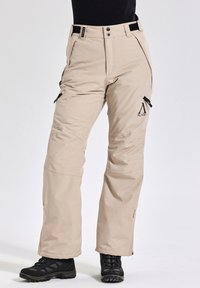 Beige geïsoleerde broek met verstelbare taille, zijritsen en logo-detail. Gemaakt van duurzaam materiaal, ontworpen voor buitenactiviteiten.