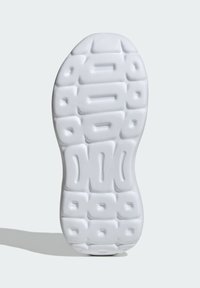 White sneaker sole featuring a textured, patterned surface with geometric indentations and ridges for traction and grip.