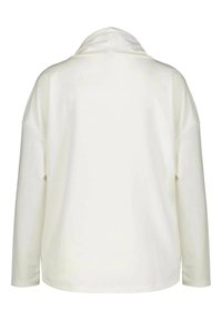 Maglia a maniche lunghe color crema con scollatura a collare morbido. Tessuto dalla trama liscia, spalle scese e orlo semplice.
