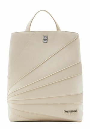 Sac à main structuré couleur crème avec anse supérieure, fermoir argenté et design à panneaux diagonaux superposés, marqué du logo "Desigual" en bas à droite.