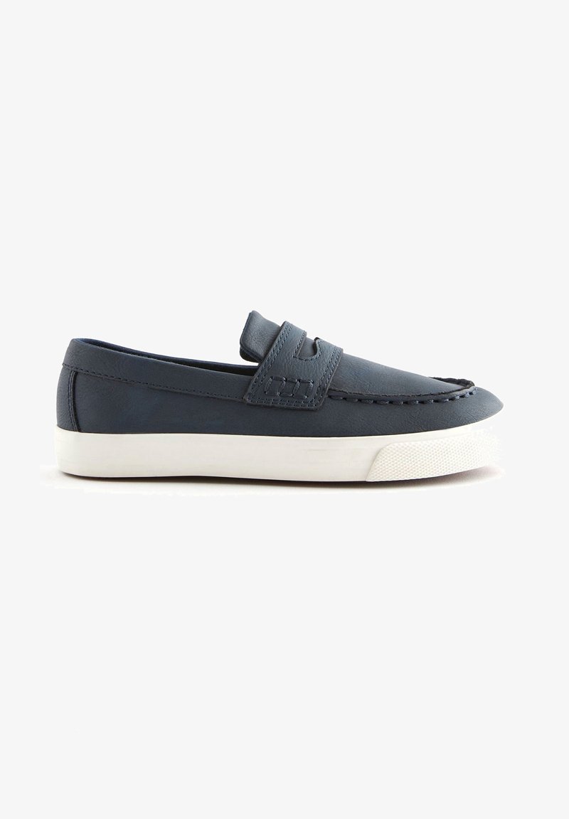 Mocassin slip-on bleu marine avec semelle en caoutchouc blanc et couture décorative, vue de côté sur fond blanc.