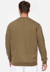 Olive green sweatshirt with a round neckline, long sleeves, and ribbed cuffs. Soft texture with a minimalist design, no visible logos or patterns.