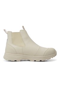 Botas Chelsea impermeables beige con un acabado suave, panel lateral elástico y suela de goma. Presenta una puntera redondeada y un tirador.