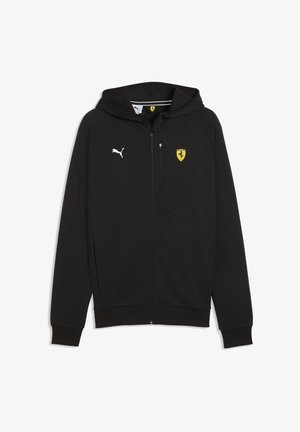 Zwarte hoodie met ritssluiting gemaakt van gladde stof, met een Puma-logo op de linkerborst en een geel Ferrari-logo aan de rechterbovenkant.
