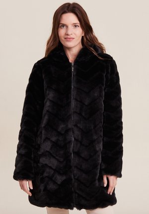 Manteau en fausse fourrure noire avec un motif en chevrons, fermeture éclair intégrale et capuche. Sa texture douce et ses longues manches augmentent la chaleur et le confort.