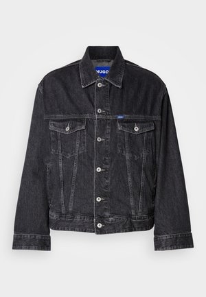 Black denim jacket featuring a pointed collar, front button closure, two chest pockets, and contrasting stitching.