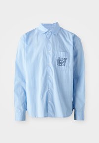 Camisa de botón de rayas azul claro con mangas largas, que presenta un bolsillo en el pecho con "OBEY" bordado en letras negras en negrita.